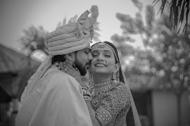 a man is kissing his lady on the cheek