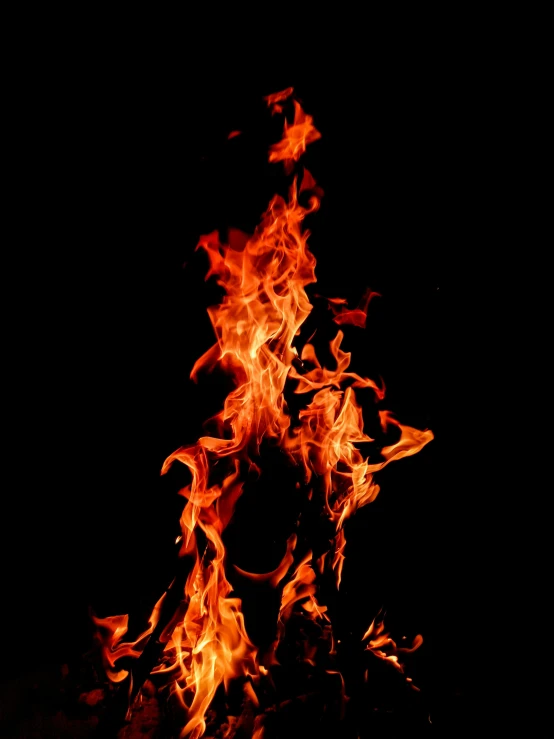 a flame is lit up against a black background