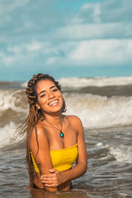 a smiling woman standing in the ocean waters