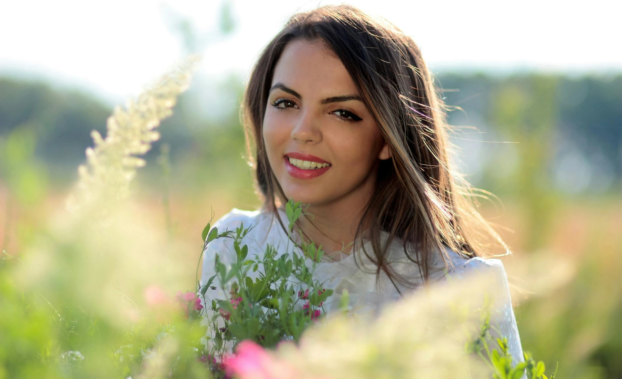 the woman is standing in the flower field