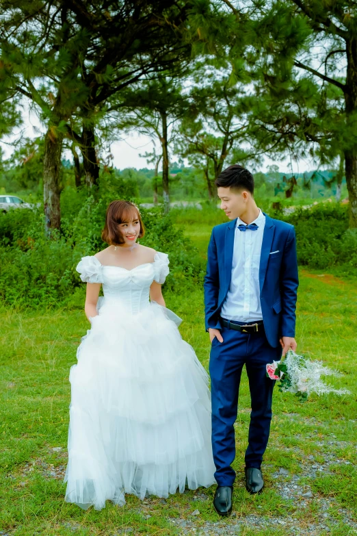 young couple in blue wedding attire standing close to each other