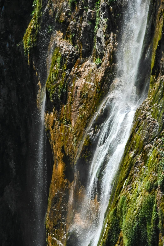 a close up of a waterfall in a mountain