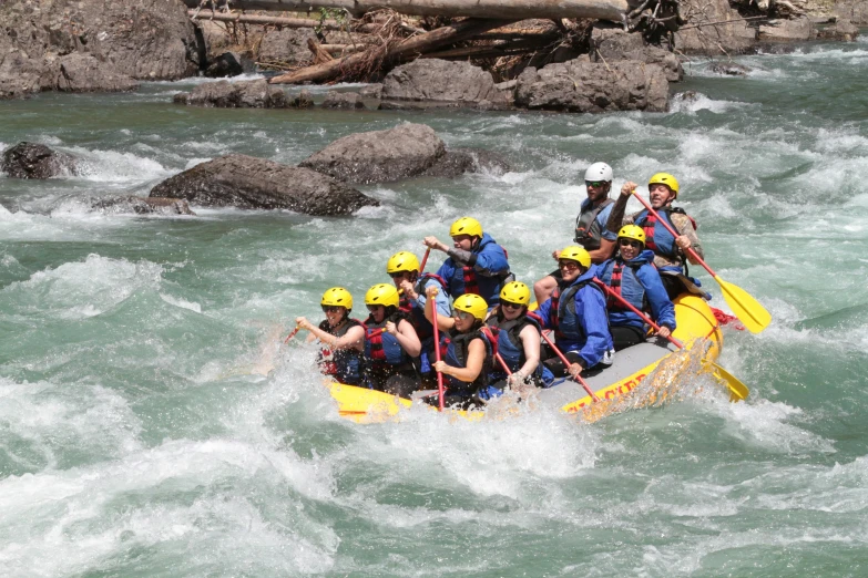 there is a group of people riding on a raft in rapids