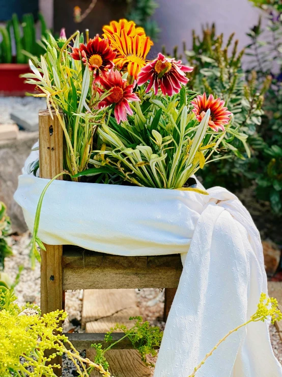 flowers are sitting in a pot on a table outside