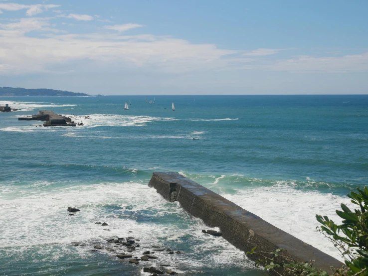 view of a body of water with a long line of small boats near the shore