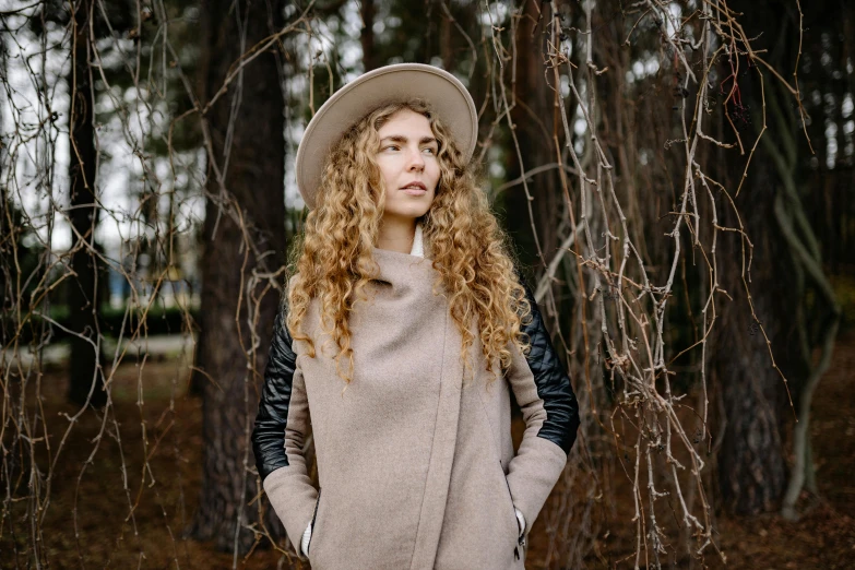 the blonde woman is wearing a hat and scarf