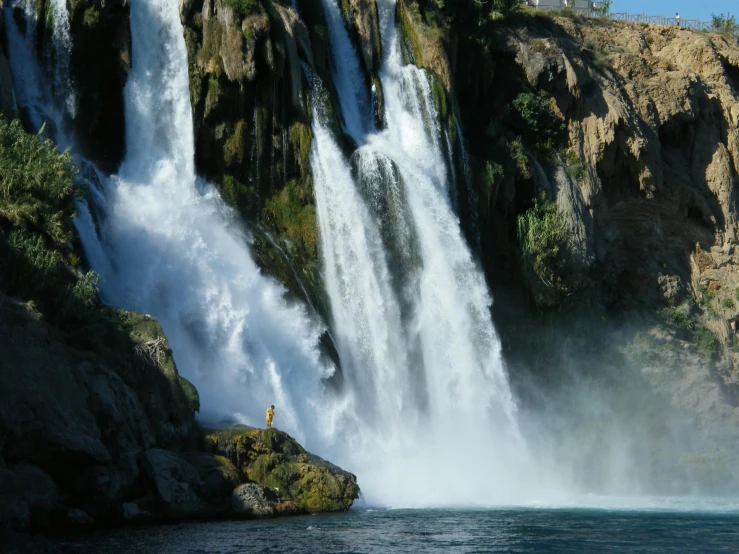 a waterfall being viewed from the river