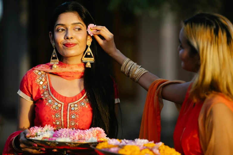 indian bride gets her hair styled and decorated