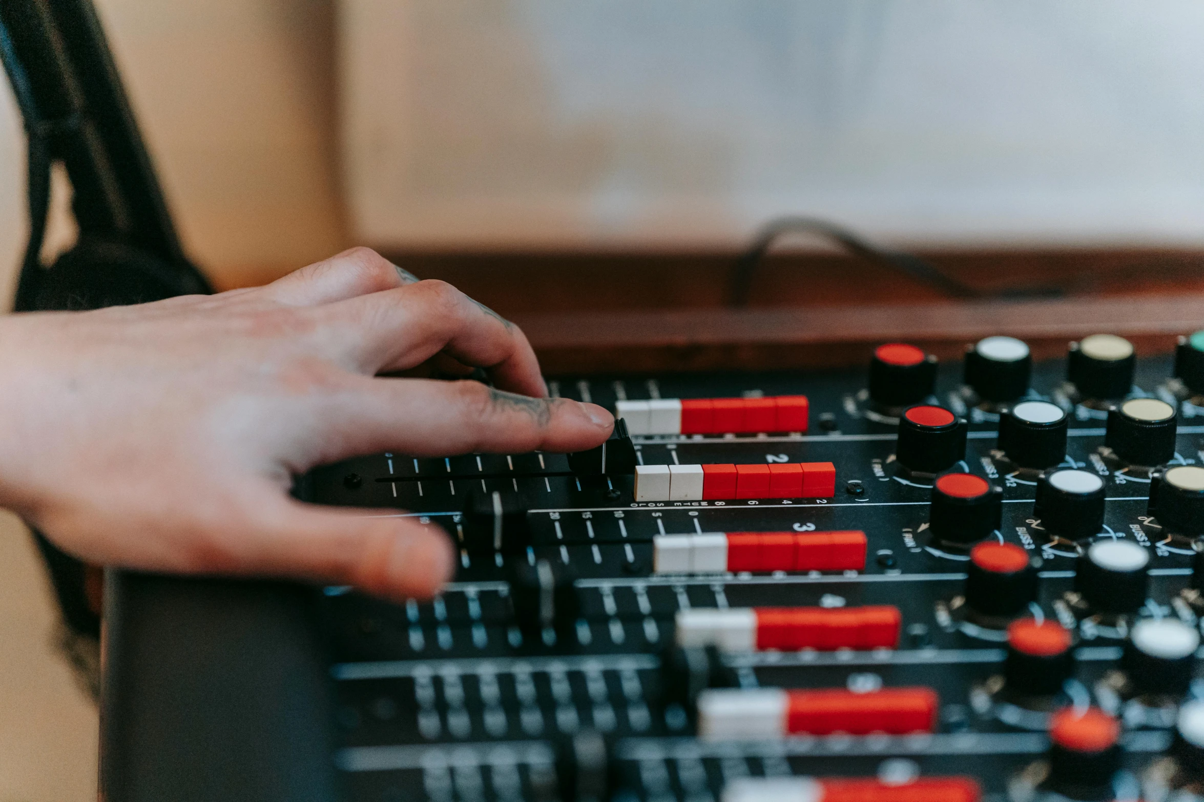 a person is using an audio mixer to record the track