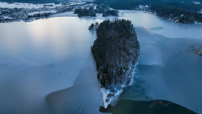 an aerial view of the water and ice covered shoreline