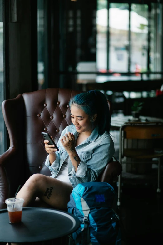 the woman is looking at her phone while sitting