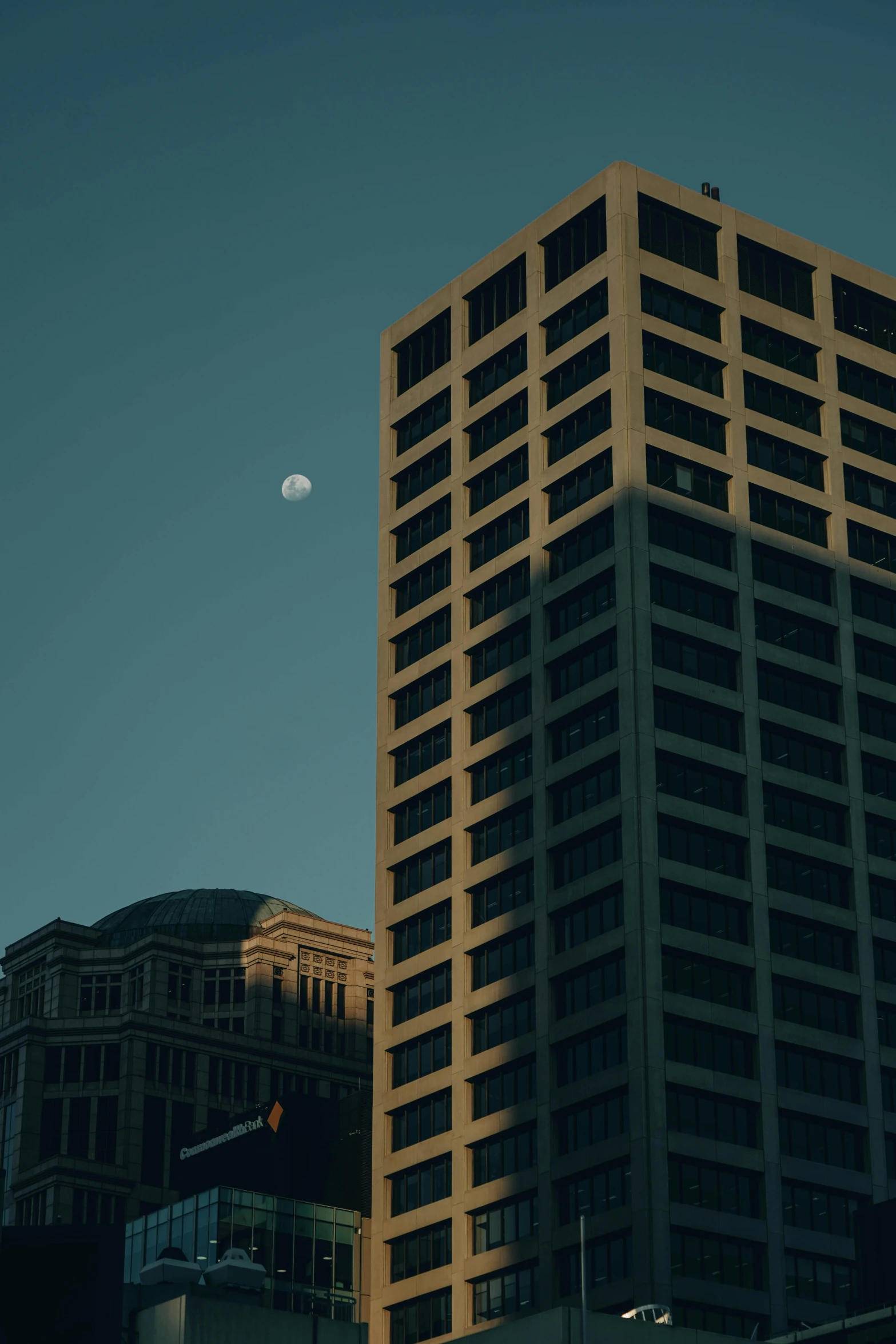 a tall building is pictured in front of other buildings