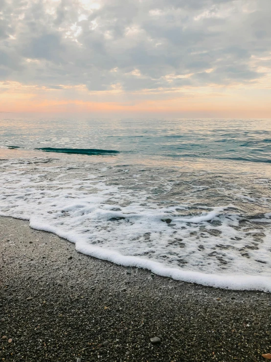 a surfboard sitting on the edge of a beach