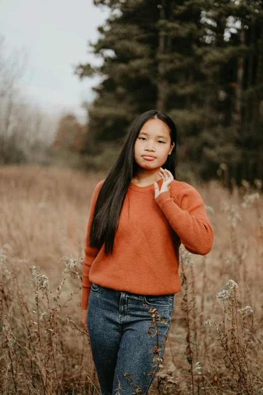 a  in a grassy area by a forrest