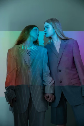 two woman standing in a colorful striped suit