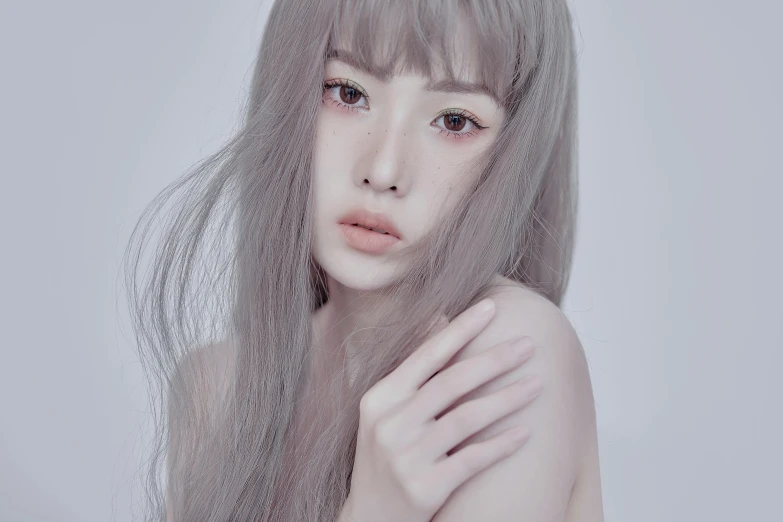 a woman with long hair posing for the camera