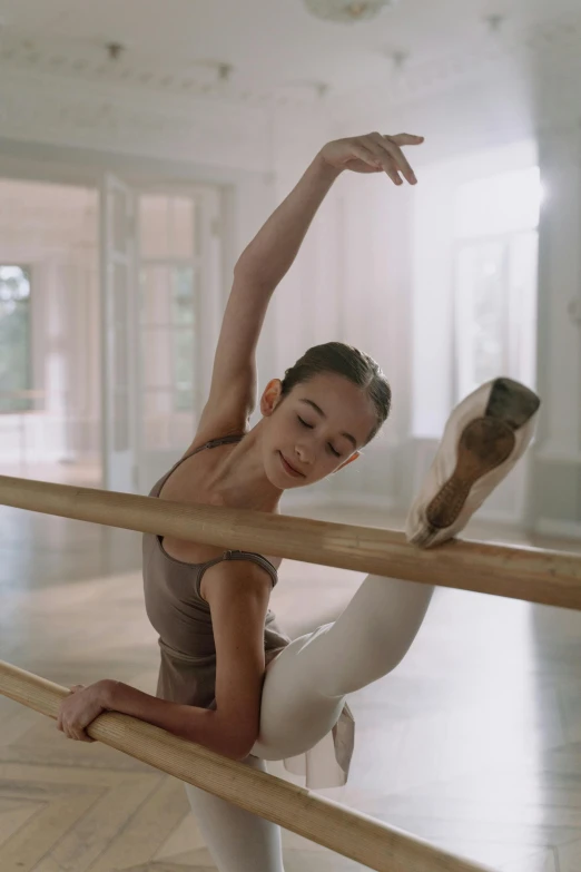 a young woman is doing a ballet pose