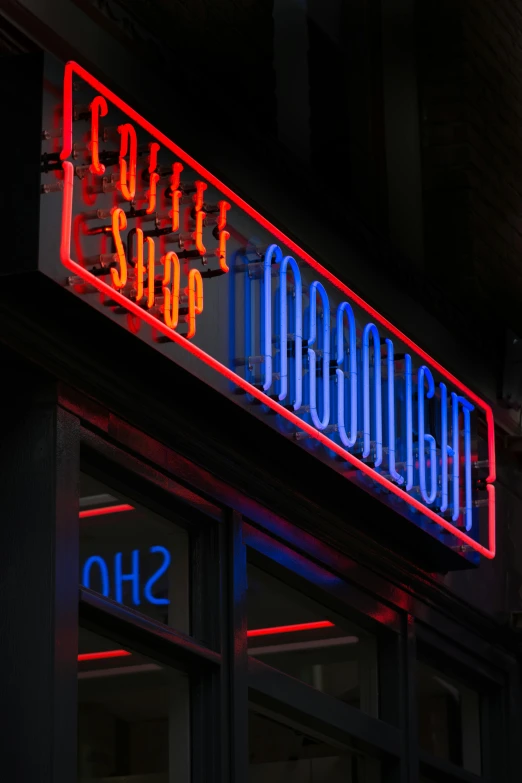 a bright store sign that has been lit up