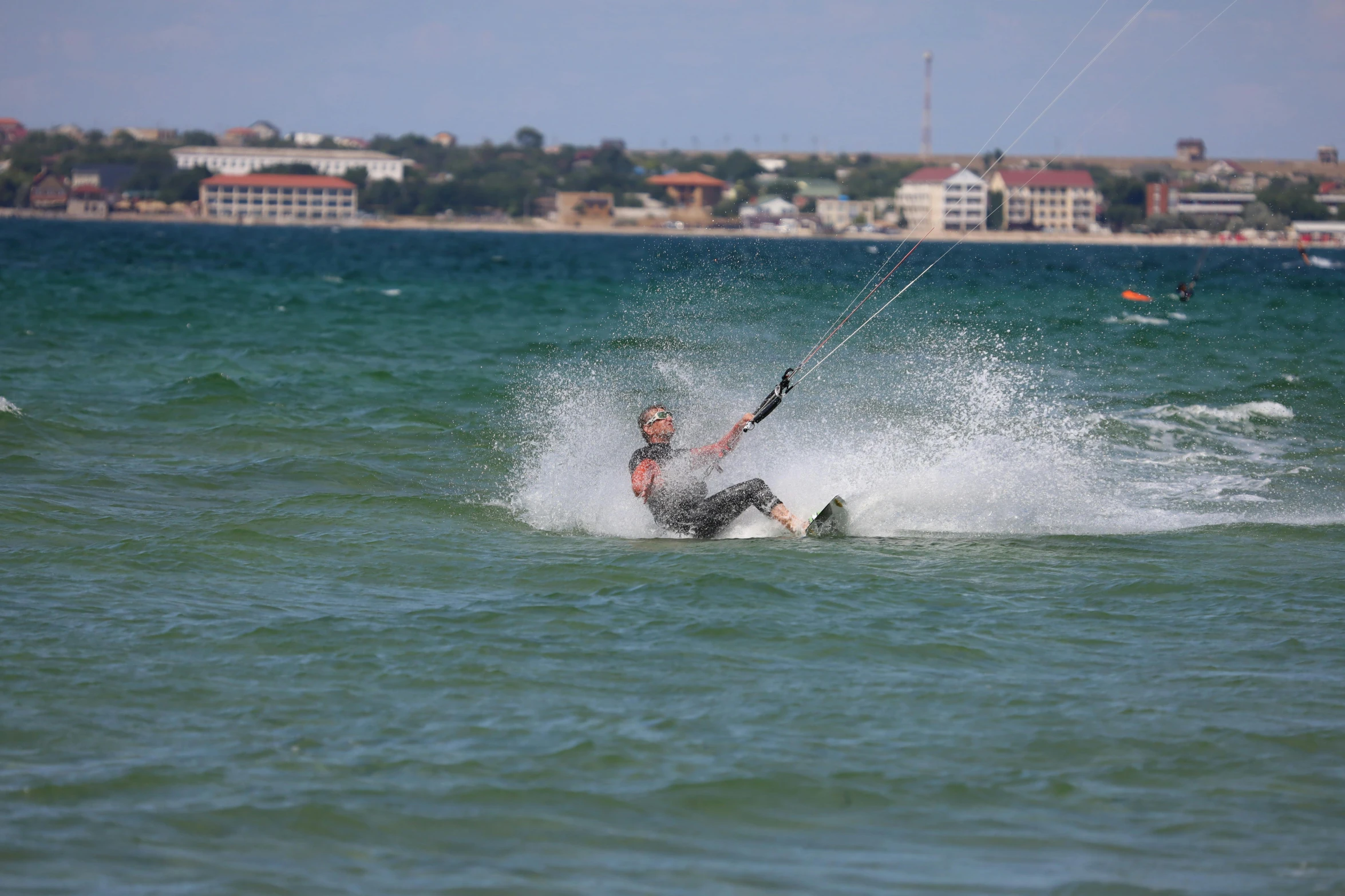 a man riding a kite board on top of water