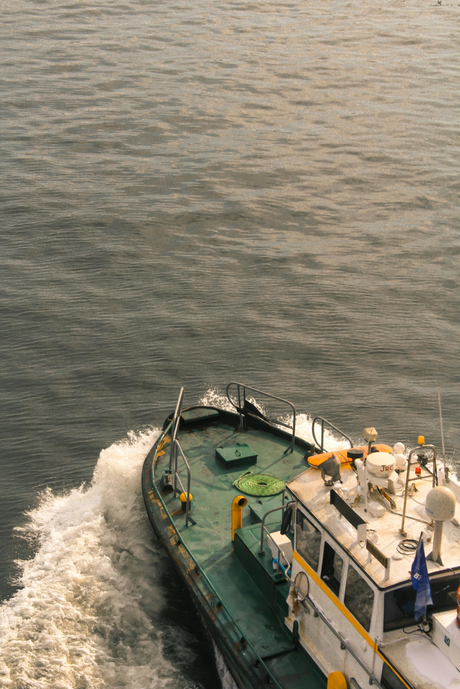 a tugboat in the water moving across the water