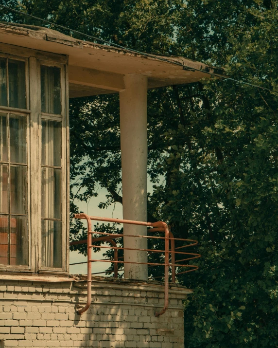 an old building with a broken window and metal railing