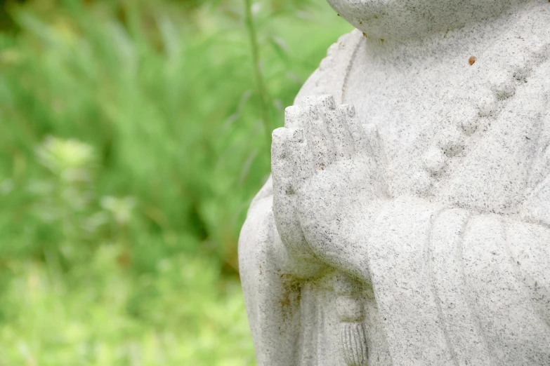 there is an image of a white statue on grass