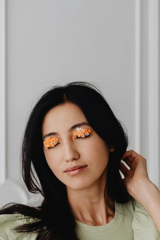 a woman with her eyes decorated with flowers