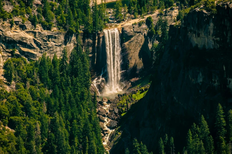 the large waterfall is coming out from the side of the hill