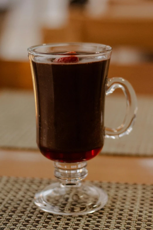 an empty glass filled with liquid on top of a table