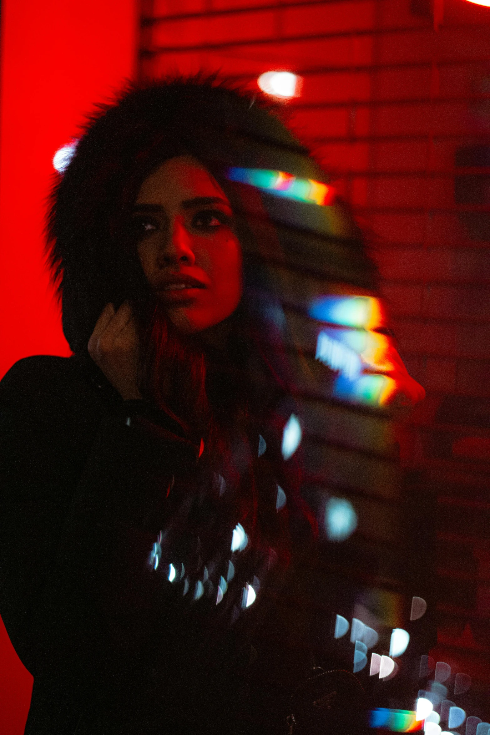 a woman standing next to a building in the dark