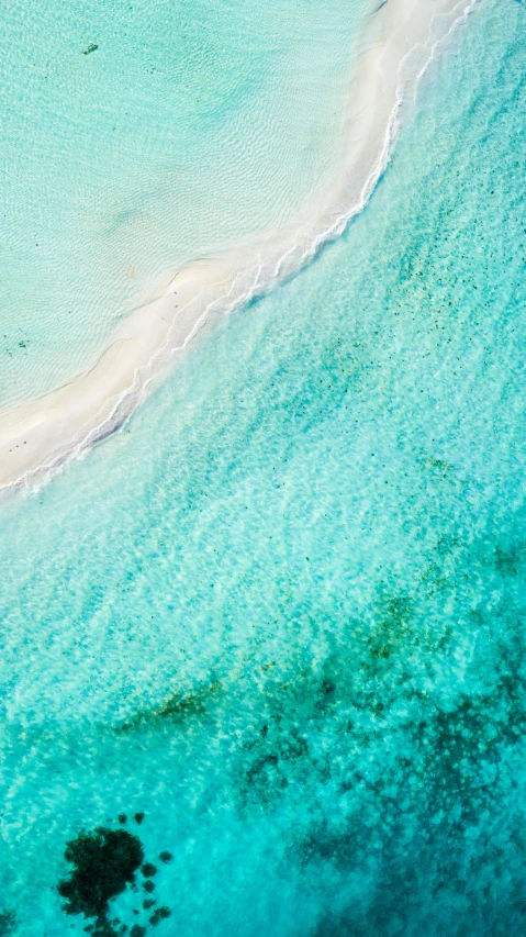 two people on the beach near some water