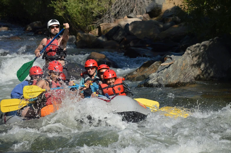 a group of rafters going down rapids on a river