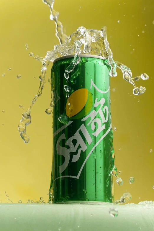 a can of soda that is exploding with some water