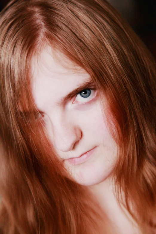 a close up po of a red - haired girl with frizzy hair