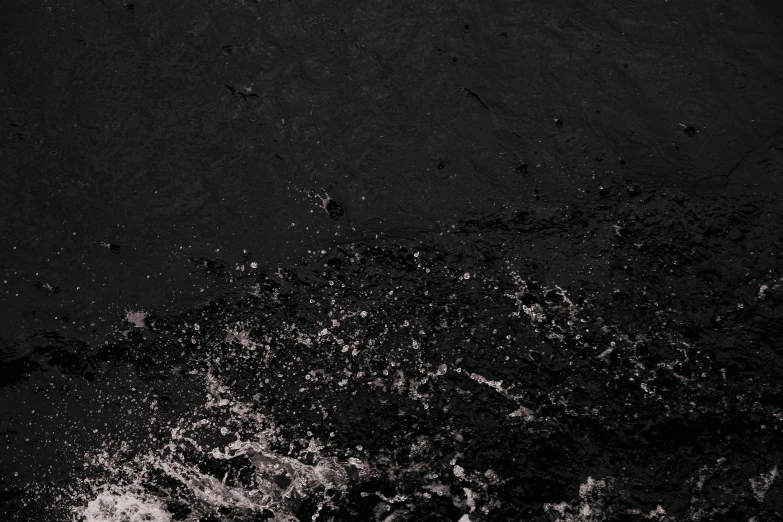 a dark and lonely beach area, with very little light from the sunlight on it