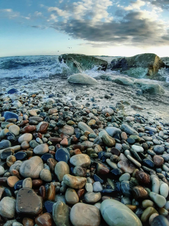 rocks and gravel at the edge of a large body of water