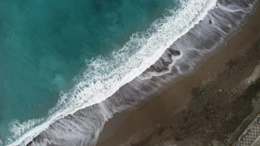 an aerial view of the beach and ocean from above