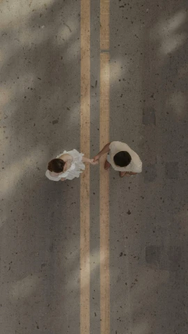 an overhead view of two women walking along the street