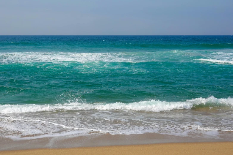 people are at the beach, swimming and riding waves