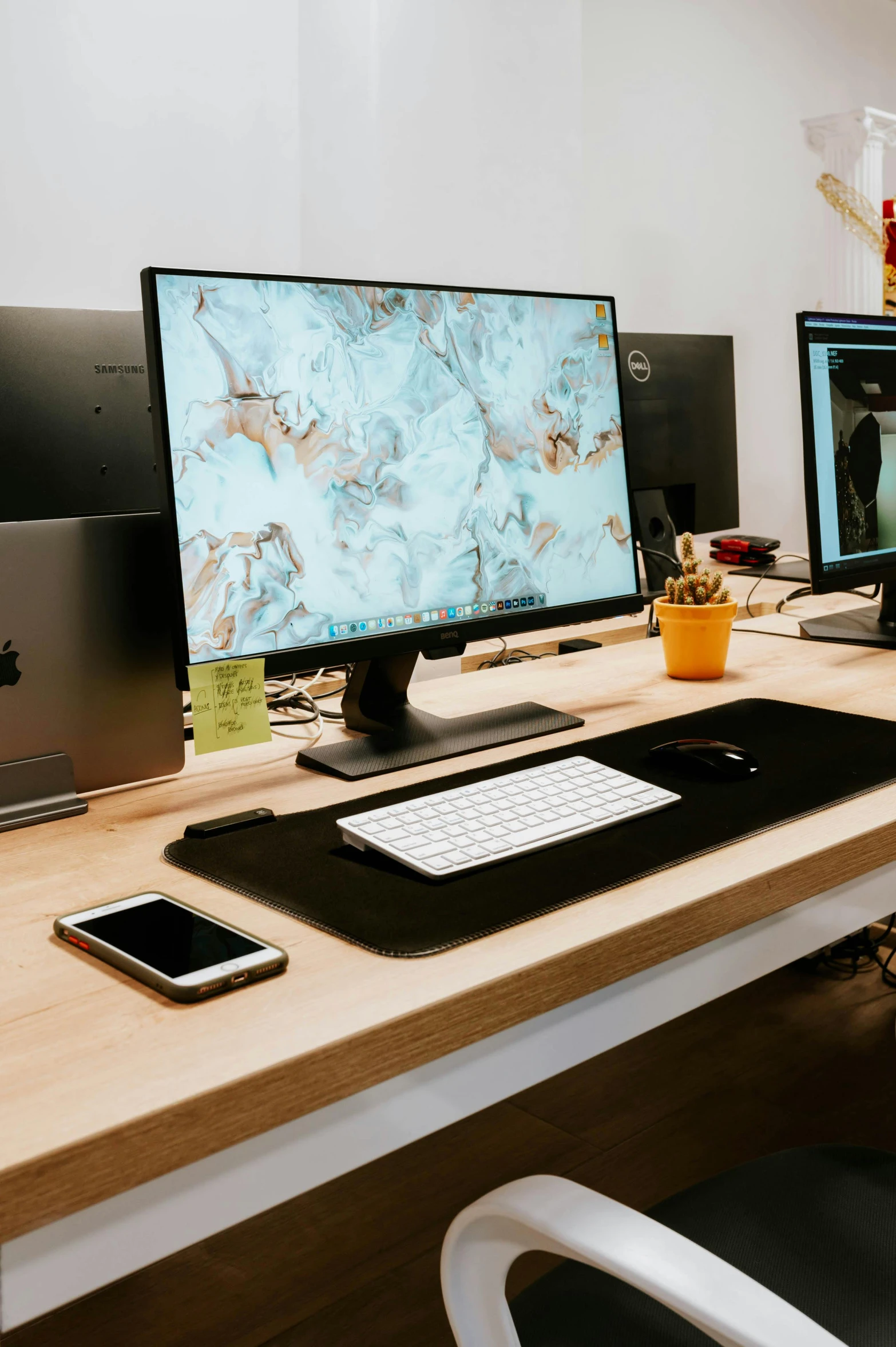 a computer desk with two monitors and laptop on it