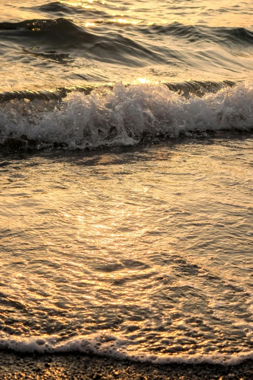 a close up s of the ocean with waves crashing in to shore