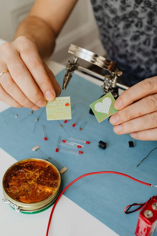 a woman using some kind of thread to stitch fabric