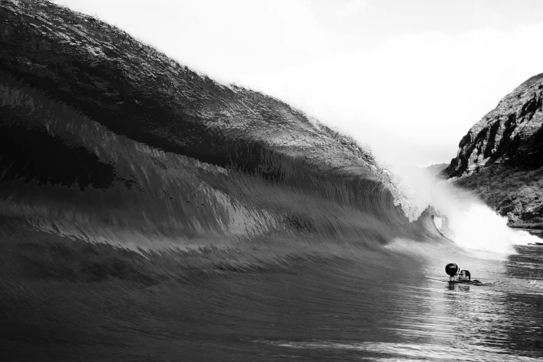 the waves are hitting around a person walking through water