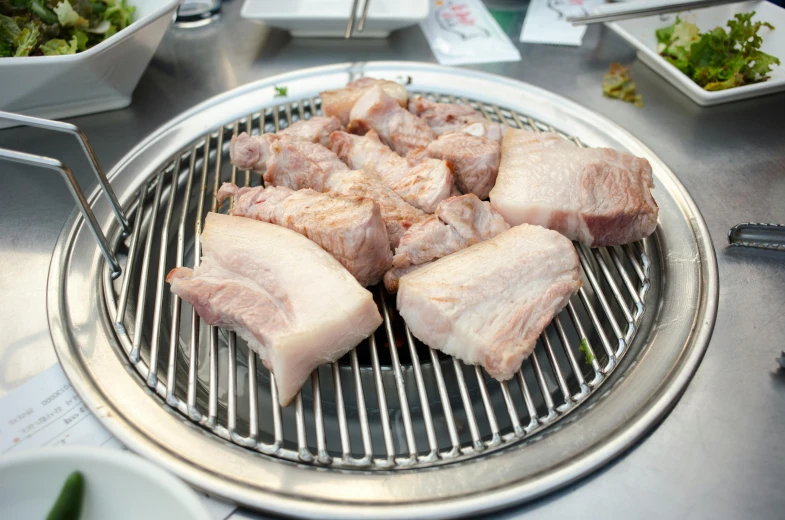 the meat is being cooked on the grill