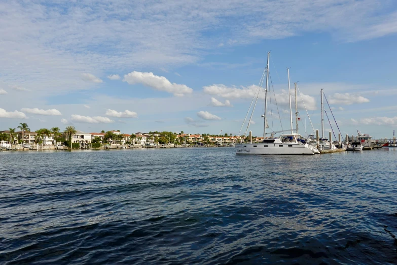 a white sail boat is in the water