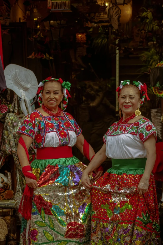 two woman in colorful outfits are posing for a picture