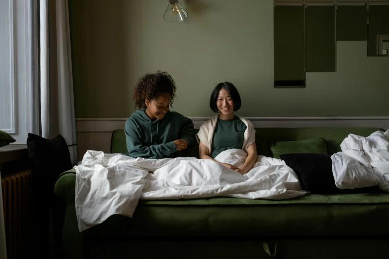 two people in a bed near a window