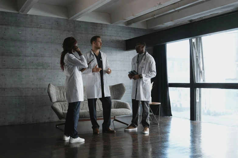 four men are standing next to each other in the room