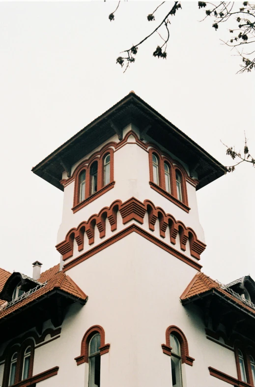 a large white building with brown chimneys and windows