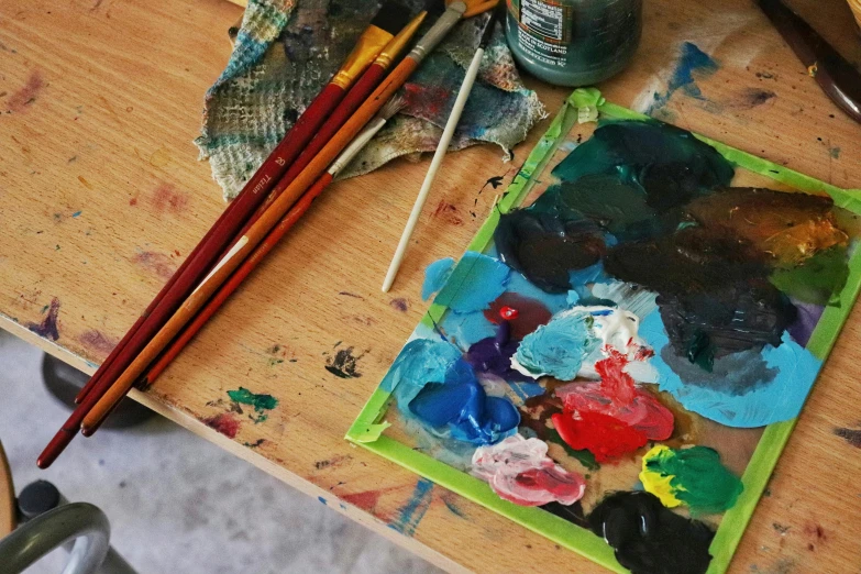 an assortment of artist supplies sit on a table